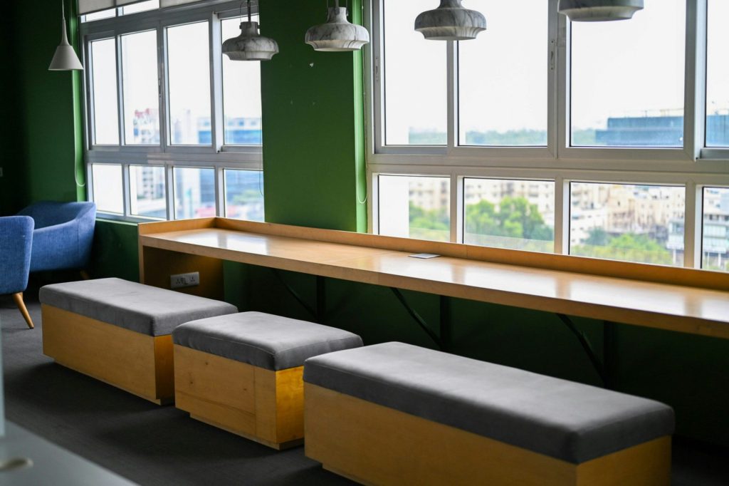 Modern seating area with large windows and city view.